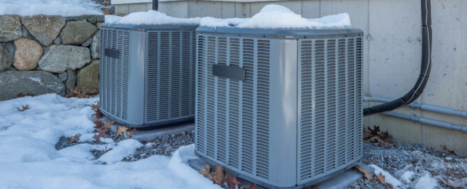 Two HVAC units outside in the snow