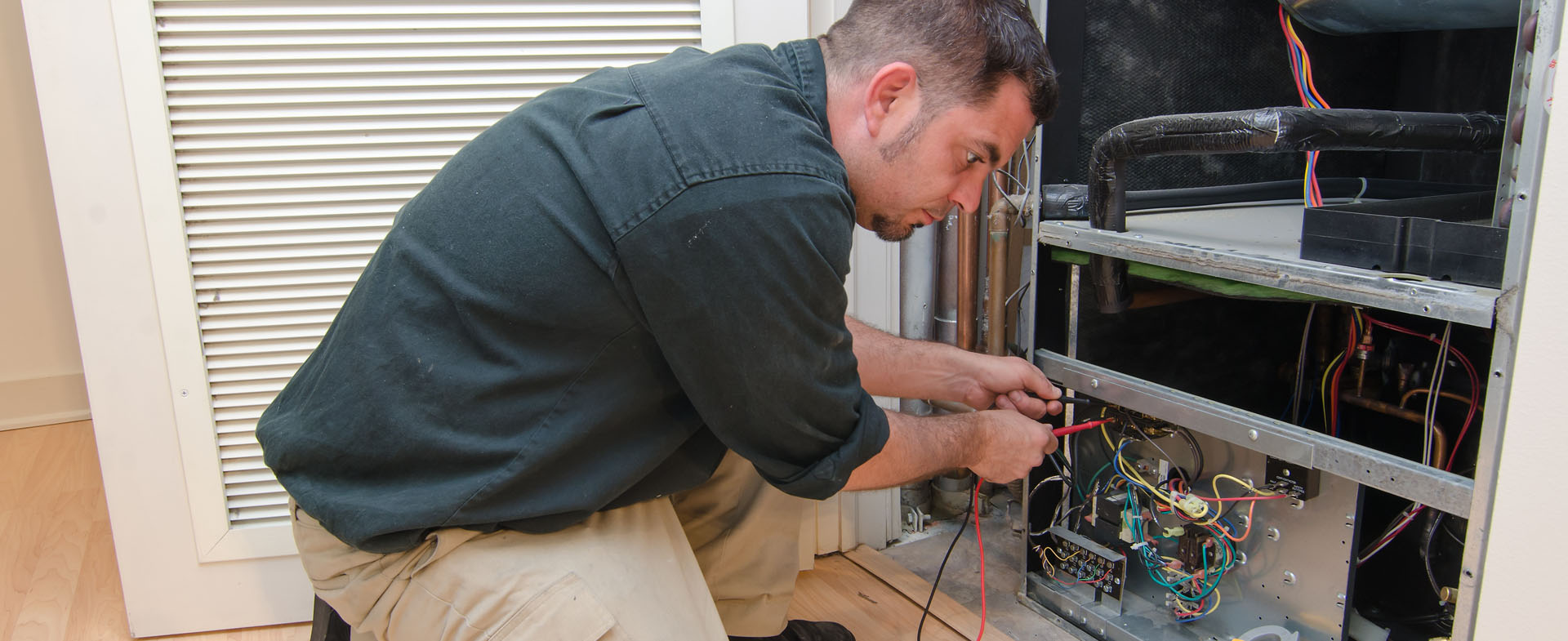 Technician working on replacing air unit wiring