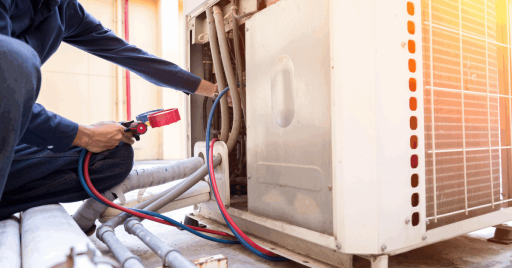 Technician performing maintenance on a HVAC unit