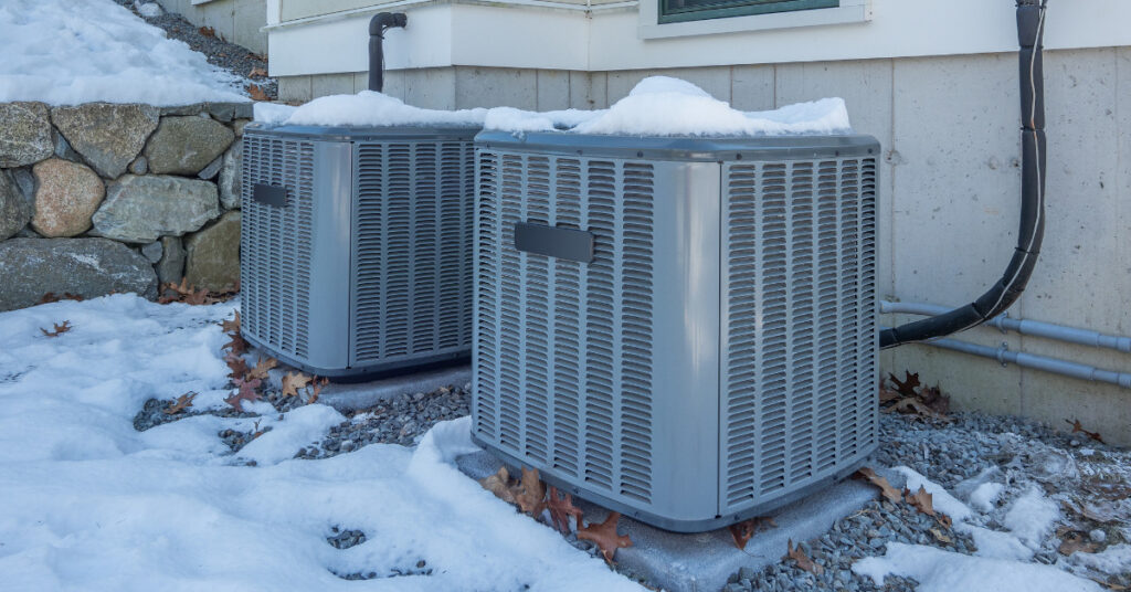 Two HVAC units outside in the snow